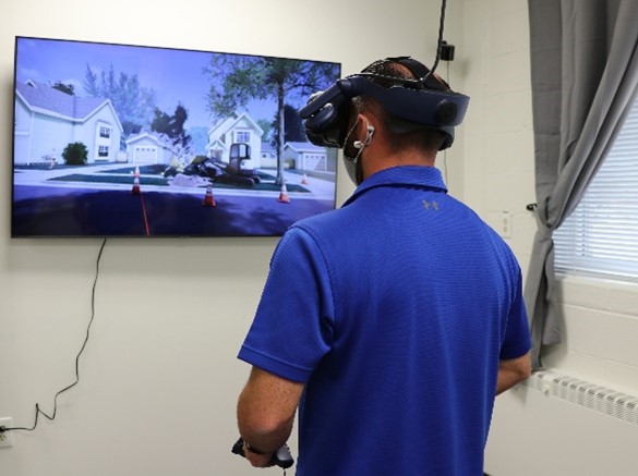 A person wearing headphones looking at a picture on a wall